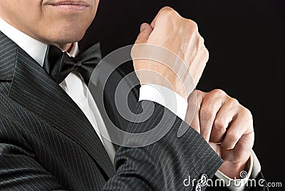 Man In Tux Fixes Cufflink Stock Photo