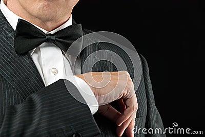 Man In Tux Tucks In Pocket Square Stock Photo