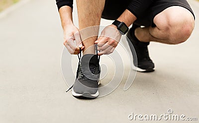 Man tying running shoes laces getting ready for run Stock Photo