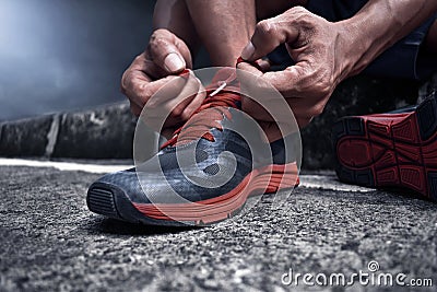 Man tying running shoes Stock Photo