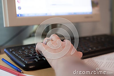 Man typing on computer keyboard with his left hand, remote work at home, Editorial Stock Photo