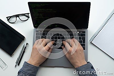 Man is typing on his laptop on white table. Top view, flat lay Stock Photo