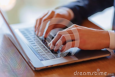 Man typing on laptop at cafe hands closeup Stock Photo