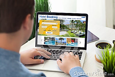 man typing laptop keyboard with online search booking hotel screen Stock Photo