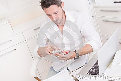 Man typing text message in office Stock Photo