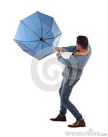 Man with umbrella caught in gust of wind on white background Stock Photo