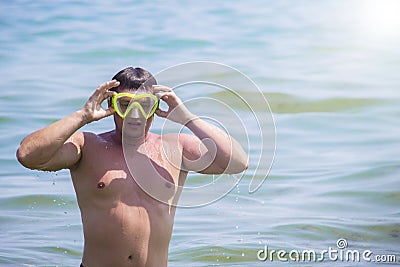 Man with an underwater mask is engaged in diving.A man in a mask floats in salt water. Stock Photo