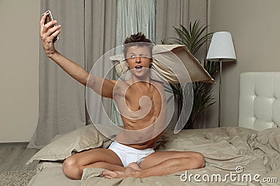 Man in underwear take selfie in bedroom Stock Photo