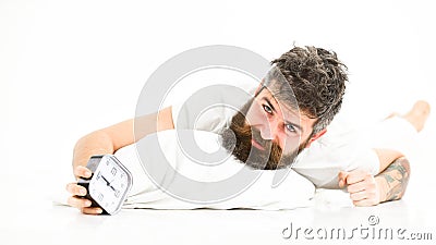 Man unhappy in morning, wants to turn off alarm clock Stock Photo