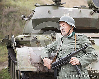 Man in uniform German soldier WW II with gun Schmeisser Stock Photo