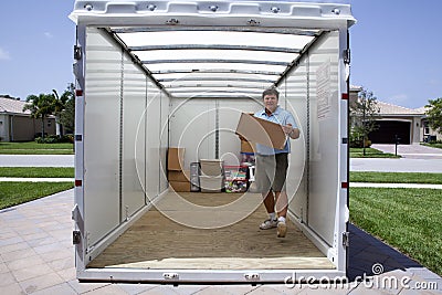 Man unloading portable storage unit Stock Photo