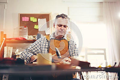 Man upholstering chair Stock Photo
