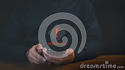 Man use a smartphone with caution warning sign for notification error. Stock Photo