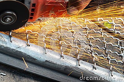 Man used angle grinder without cover guard cutting metal net Stock Photo