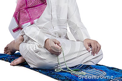 Man uses beads to dhikr Stock Photo