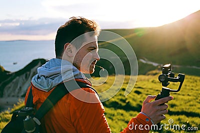 Man uses DJI Osmo Mobile gimbal with iPhone 7 Plus Editorial Stock Photo