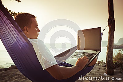 Man uses laptop remotely Stock Photo