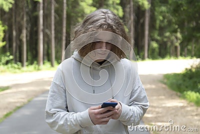 The man uses a smartphone to access the Internet. Using a smartphone Stock Photo