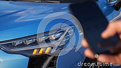 Driver controls car and removes signalling using smartphone Stock Photo