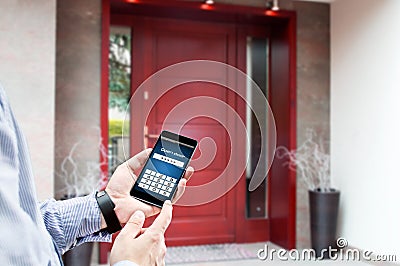 Man uses smartphone to open the door. Stock Photo