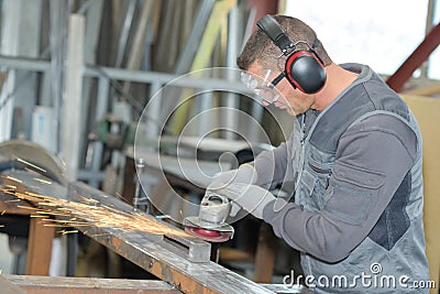 Man using angle grinder Stock Photo