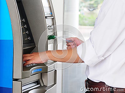 A man using ATM machine Stock Photo