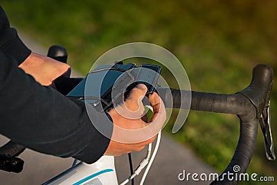 Man using bicycle speedometer. Wireless sensor for measuring speed and distance Stock Photo