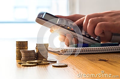Man using calculator to count money savings and living costs. Stock Photo