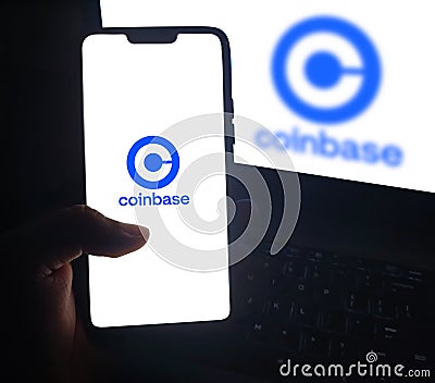 Man using Coinbase on the mobile screen for dealing in cryptocurrency globally, editorial background Editorial Stock Photo