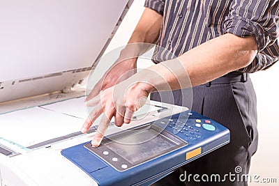 Man using copier to make copies of documents Stock Photo