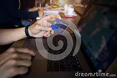 Man using credit card payment shopping online in public cafÃ©. Internet data fraud risk Stock Photo