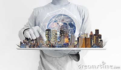 A man using digital tablet with modern building and global network connection technology hologram. Element of this image are furni Stock Photo
