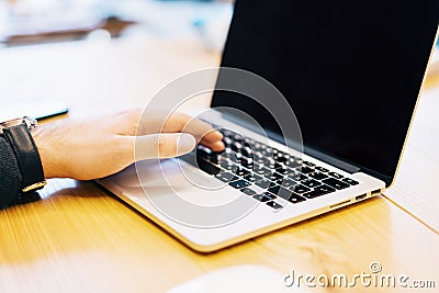 Man using empty laptop screen on table Editorial Stock Photo