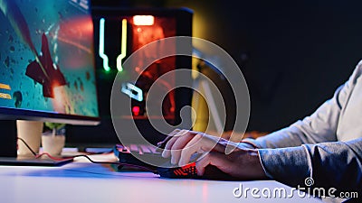 Man using gaming RGB lit mouse to shoot asteroids in spaceship flying videogame Stock Photo