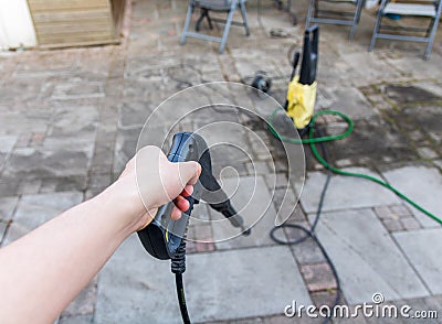 Man using a high pressure syringe to clean tiles Stock Photo