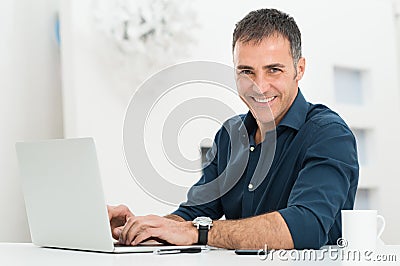 Man Using Laptop At Desk Stock Photo