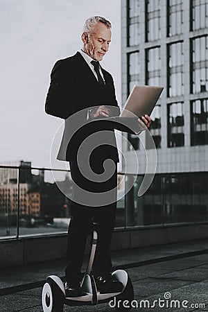 Man is Using a Laptop on Gyroboard Stock Photo