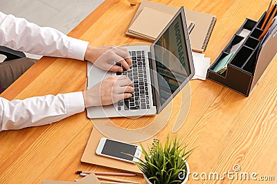 Man using laptop to pay mortgage loan online in office Editorial Stock Photo