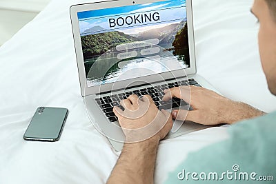Man using laptop to plan trip. Travel agency website Stock Photo