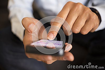 Man using a mobile phone on sofa, indoor Stock Photo