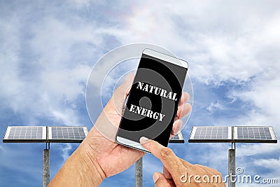 Man using mobile smart phone control with Outdoor small solar pa Stock Photo