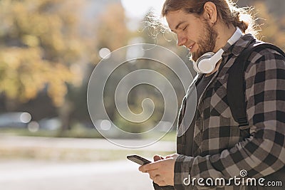 Man using mobile smart phone. Young man texting on his smartphone in the city. Close up of cheerful adult using mobile Stock Photo