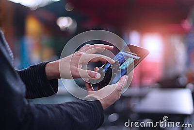 Man using mobile smartphone for online banking in cafeteria Stock Photo