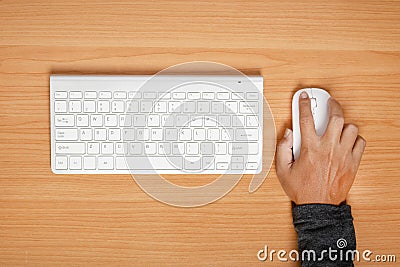 Man using mouse and keyboard on wooden table. top view Stock Photo
