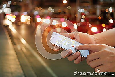 Man using navigation app on the smartphone on street at night Stock Photo