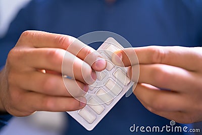 Man Using Nicotine Gum To Quit Smoking Stock Photo