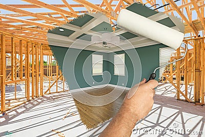 Man Using Paint Roller to Expose Finished Build of House Construction - Before and After Stock Photo