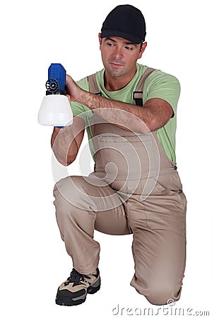 Man using paint sprayer Stock Photo