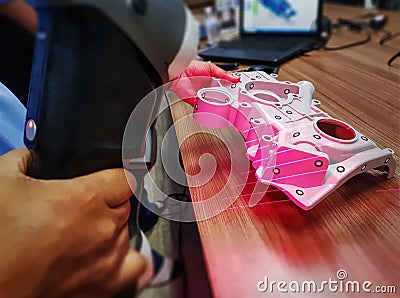 Man Using Portable Scanner to Scan 3D CAD Model of Complex Mechanical Part Stock Photo