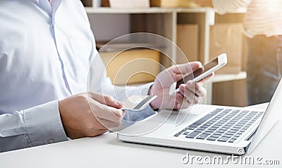 Man using smart phone and credit/debit card register payments on Stock Photo